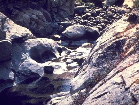 Pothole erosion in solid granite, Sierra Nevada Mount, California.
