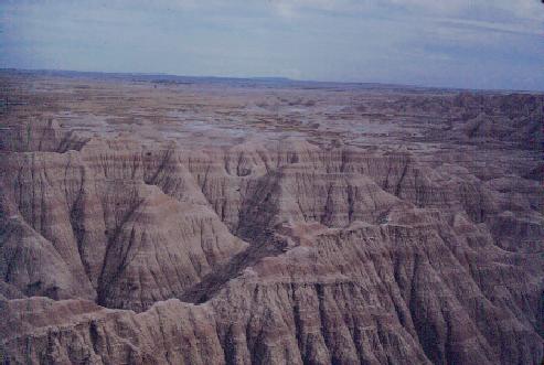 Badlands. Notice layers of rock and well-developed erosion channels.